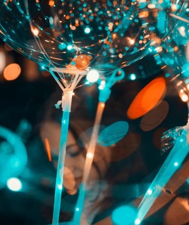 Colorful bokeh effect with balloons and party lights creating a festive atmosphere.